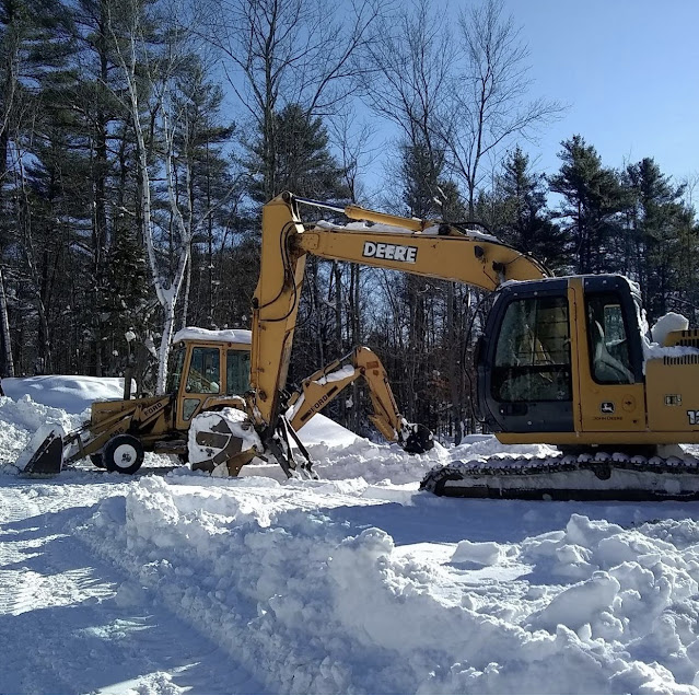 Backhoe and excavator in snow