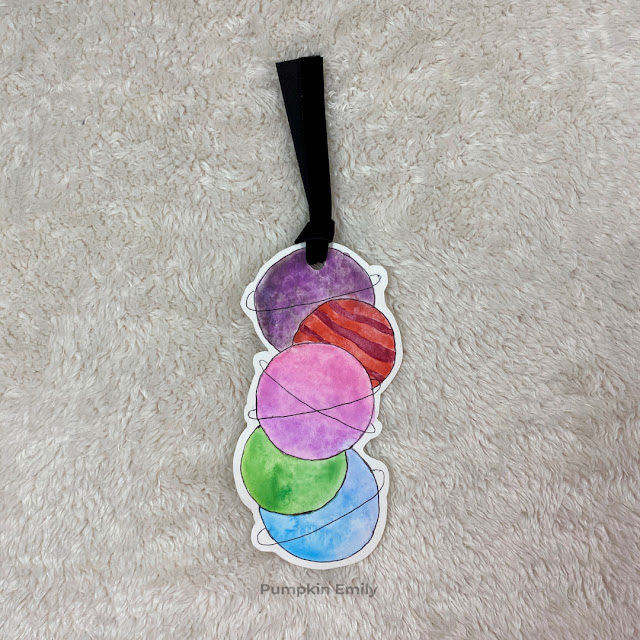 A planet bookmark with five watercolor planets.