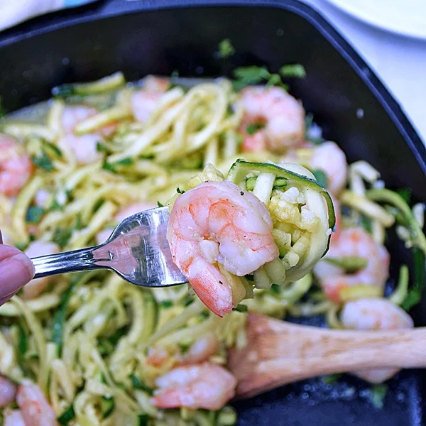 Shrimp Scampi Zoodles | by Life Tastes Good is a lower carb version of a traditional Shrimp Scampi recipe typically served over pasta. This recipe still has all the fresh tasting garlic and buttery goodness of the traditional recipe, but is served over zucchini noodles, or the more fun way of saying it 'zoodles', to get rid of all those carbs from the pasta. Just for the record... I didn't miss the pasta at all!