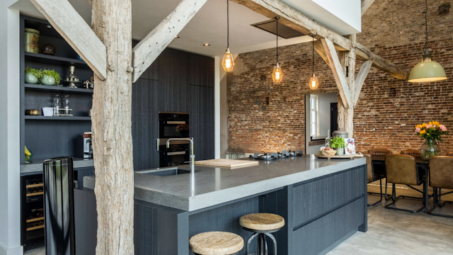 Beautiful rustic modern farmhouse kitchen with exposed brick in barn conversion