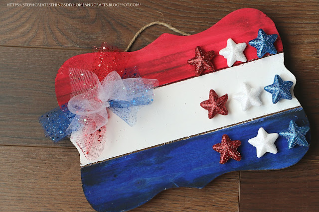 Close-up of Fourth of July wooden sign