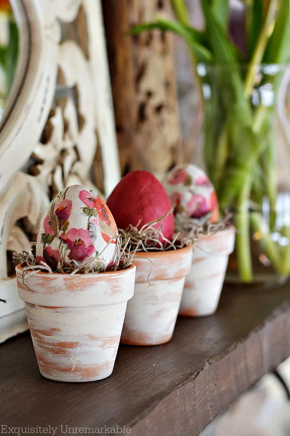 Decoupage Easter Egg Pot Nests on a fireplace mantel