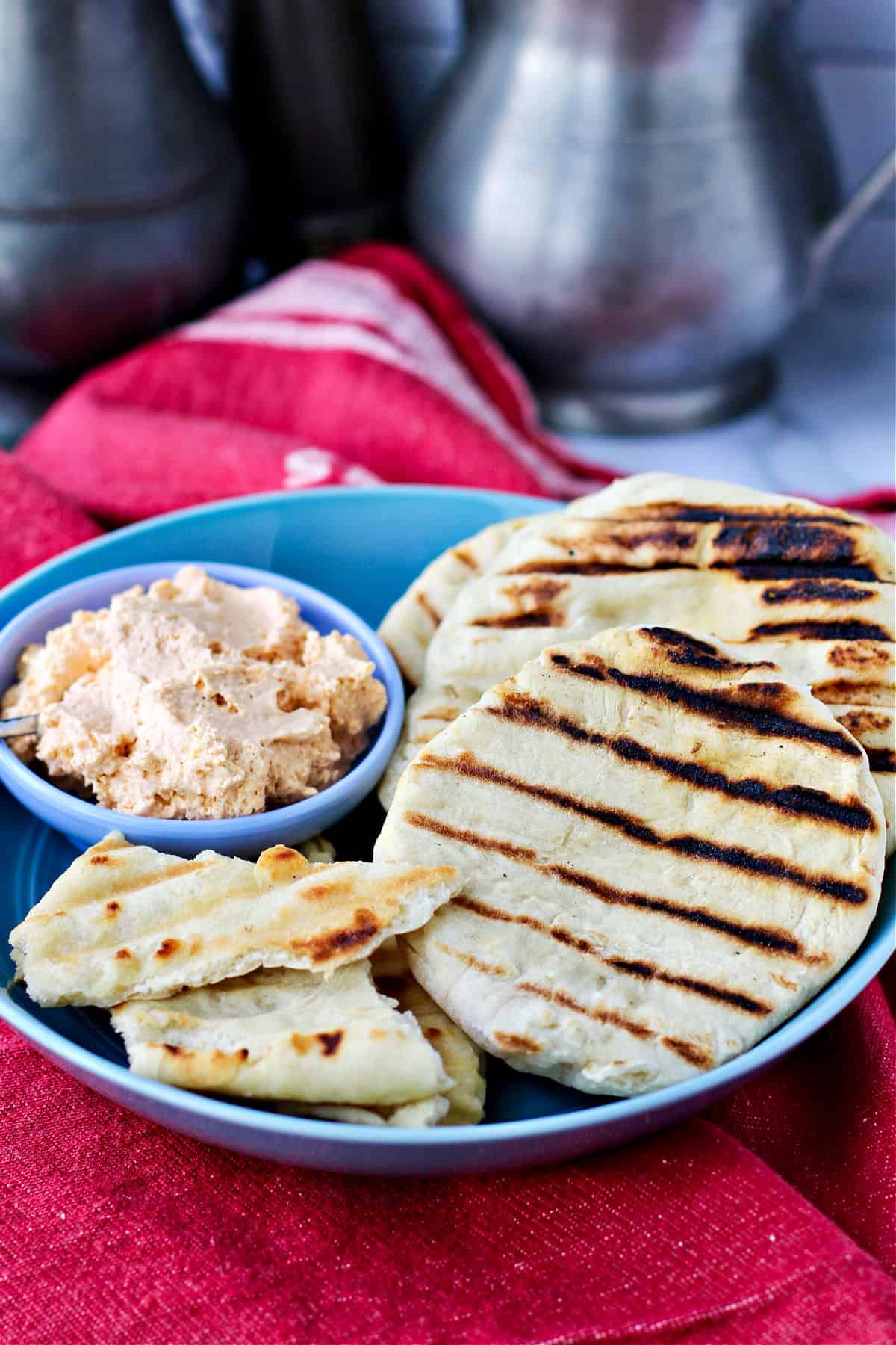 Grilled Flatbreads in a bowl with a dip.