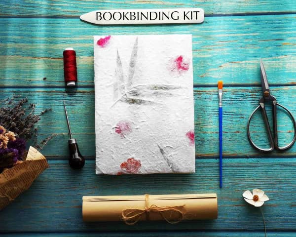 bookbinding kit flat lay shows included tools and finished book
