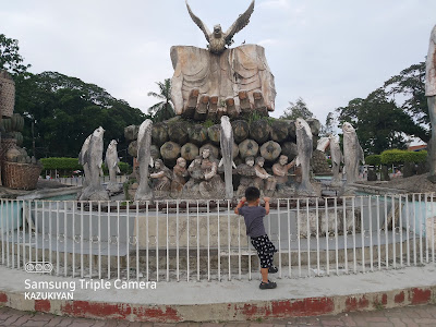 Panabo City Freedom Park with wide angle of bighand statue and fish