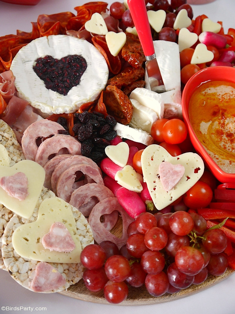 Valentine's Day Cheese and Charcuterie Board - easy, pretty, delicious grazing board filled with pink & red foods to celebrate love day at home! by BirdsParty.com @birdsparty #cheeseboard #charcuterieboard #valentinesday #recipes