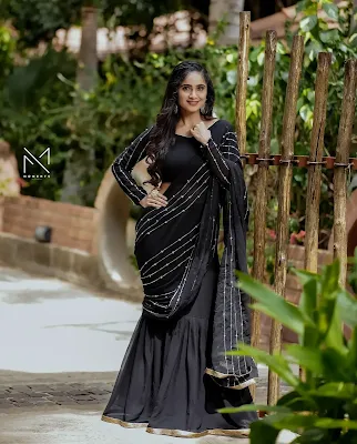 Tejaswini Gowda wearing a traditional saree, looking graceful and elegant in a sophisticated pose