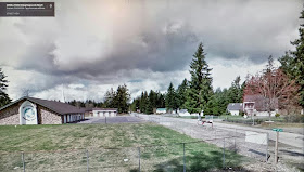 Entrance to the New Testament Christian Church - NTCC - Bible School circa 1990.   On the left was the Main Chapel used then - "The Church Behind The Fence" (with globe).   On the right, behind the reddish tree, is   the house custom built for the kekels and  where, Julie alleges, she was raped by Michael Craig Kekel - now NTCC's CEO.