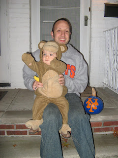 sitting on the step with daddy and this stupid Mets pumpkin