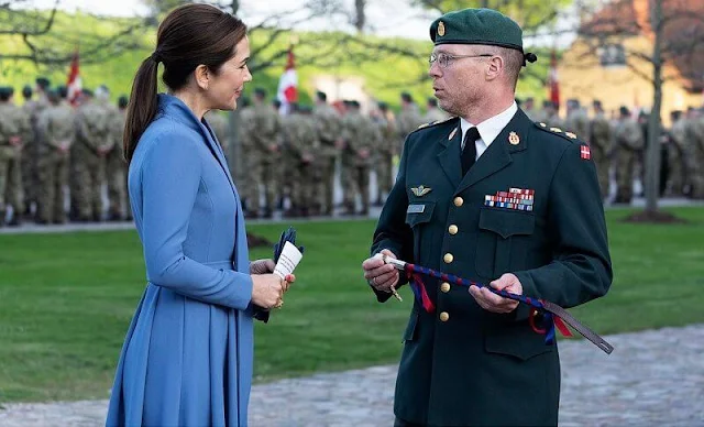 Crown Princess Mary wore a blue coat dress. The Royal family lit their candles at 8pm, the exact time that the Germans surrendered