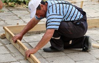 Bekir makes the wooden forms, careful to get them level