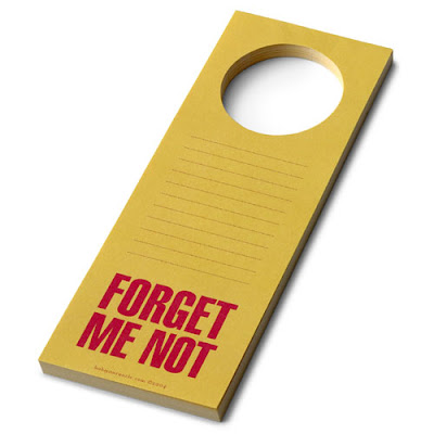 yellow door hanger pad with red writing saying Forget Me Not