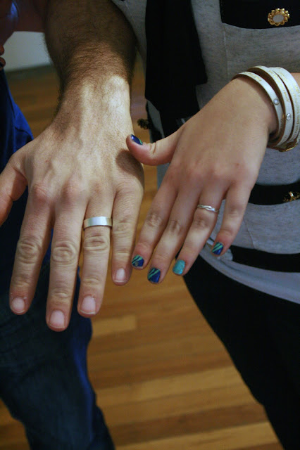 Kristen and Kevin showing off their wedding bands after spending the day making them for each other.