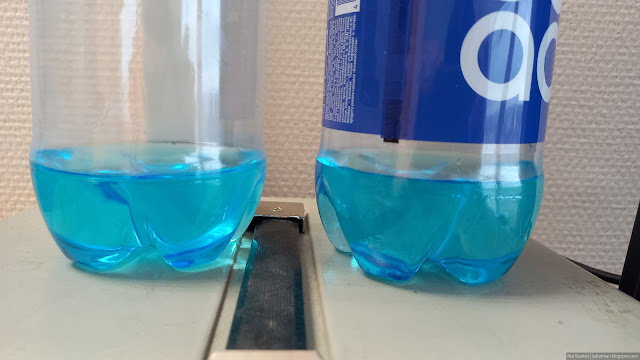 Две бутылки с налитой голубой жидкостью