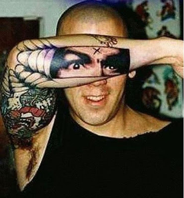 Creative Tattoo on his arm illusion Tattoo of his face on his arm