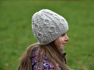Girl modelling in hat knitted with cable stitches
