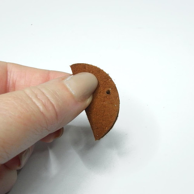 Brown suede circle folded in half