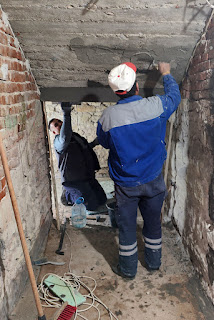 Both working on the ceiling