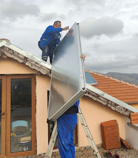 Hefting the panel up onto the roof