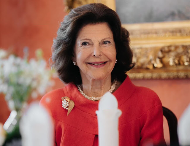 Queen Silvia wore a red jacket and red skirt, Chanel pumps, pearls necklace, brooch and diamond earrings