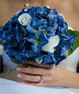 Blue hydrangeas are offset by the brilliant white of roses in this silk 