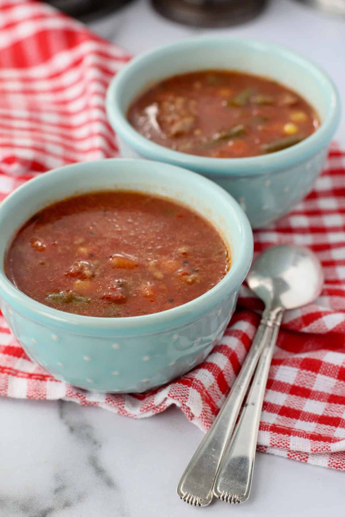 Easy Slow Cooker Beef and Vegetable Soup in small blue bowls.