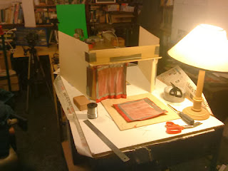 Photograph of back of theatre set, showing aluminium wire mesh backing on red curtain to create folds.