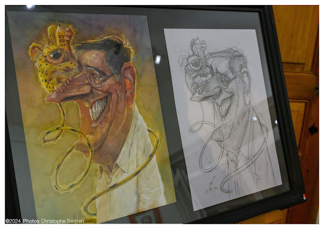 Picture of a watercolor caricature of a man with a yellow marsupial on his nose