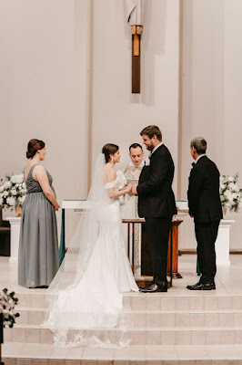 bride and groom at altar holding hands