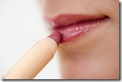 woman applying lipliner