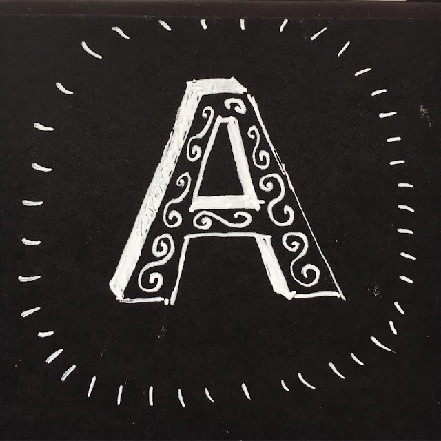 Letter A with decorative elements. Drawn with white ink on black paper. By Boriana Giormova