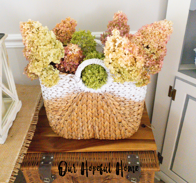 painted seagrass basket filled with dried hydrangeas