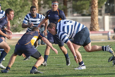 BYU Rugby Prop Mike Price lunges forward to meet a would-be tackler
