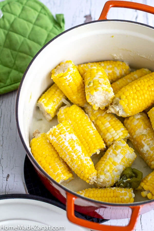 FInished corn boiled in an orange pot.