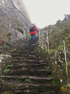 Climbing the stone steps to the top of Skellig Michael, County Kerry, Ireland