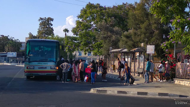 Crowds boarding a bus heading to the village