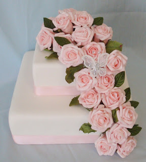 2 tier wedding cake with pink roses and butterfly