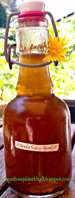 a bottle of homemade dandelion syrup decorated with a dandelion flower