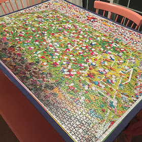 Large puzzle of a soccer game laying on kitchen table