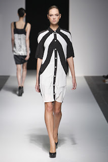 A model wearing a black and white dress on the Devastee catwalk