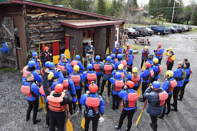 A group of rafters listening to the safety speech at Adirondac Rafting Company