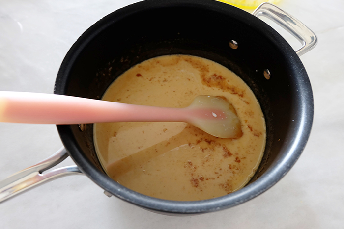 mixing the dairy into the saucepan with caramelized honey