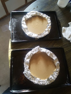 Two pumpkin pies ready to be baked