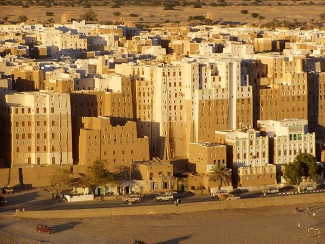 The city of Shibam, located in the central-western area of Hadhramaut Governorate, in the Ramlat al-Sab`atayn desert, is best known for its towering mudbrick skyscrapers. This small town of 7000 is packed with around 500 mud houses standing between 5 and 11 stories tall and reaching 100 feet high, all constructed entirely of mud bricks. The bizarre skyline that the high rise buildings bestow upon the city has earned Shibam the moniker "Manhattan of the Desert."