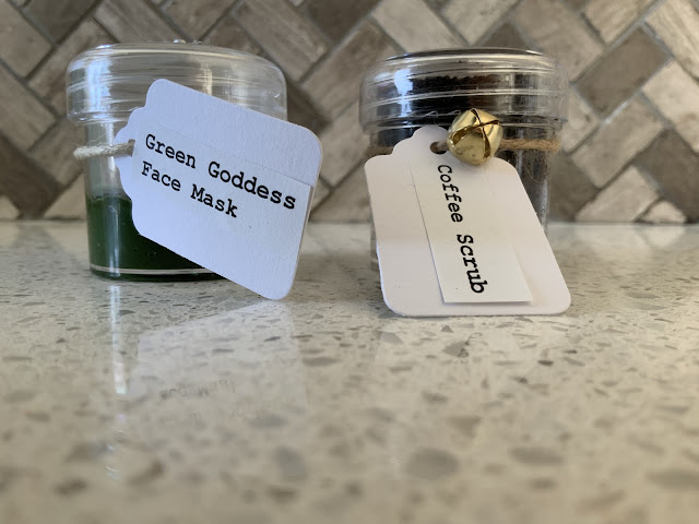 two containers of natural skincare products; green goddess and organic coffee scrub