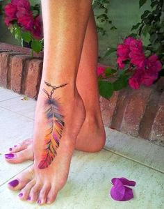 Colorful feather tattoo on feet