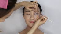 Modern Oriental Bridal Makeup -  Line the eyes with gel eyeliner on the upper lashline then line in the rim of the eyes