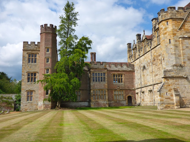 Part of the building of Penshurst Place in Kent, with a striped lawn in front