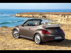 Rear 3/4 view of 2013 Volkswagen Beetle Convertible 70s Edition at ocean