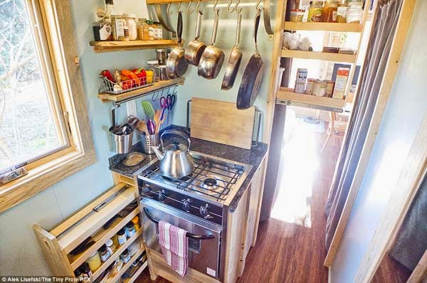 Slide-out drawers hide pantry shelves and spices.